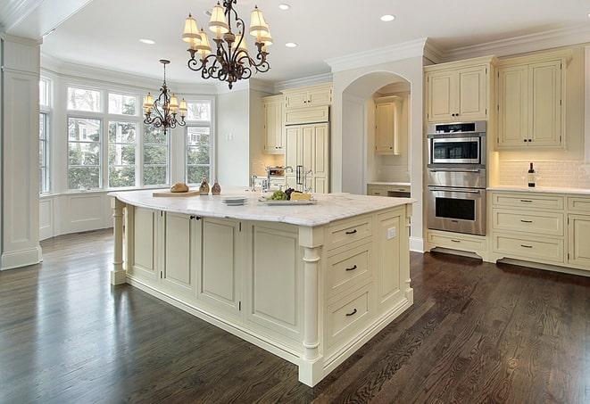 close-up of hand scraping laminate floors in Ada